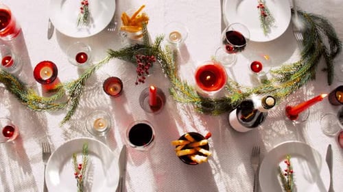 Festive Christmas Table Setting with Candles and Wine