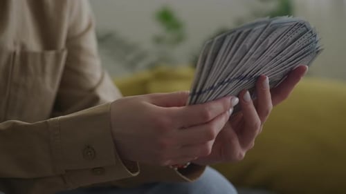 Pivoting Around Woman Holding Money In 100 Dollar Bill