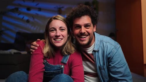 Screen View of a Young Caucasian Couple Having a Video Call Conference Using a Laptop Waving Hands
