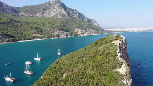Aerial View of Anchored Boats by Islet and Scenic Coastline on Mediterranean Sea