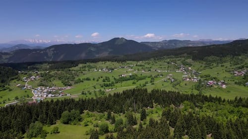 Mountain Village Between Alpine Meadows And Pine Forests