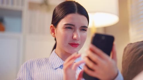 Young Woman Using Phone at Home