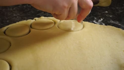 Cutting Cookie Dough Circles on Counter