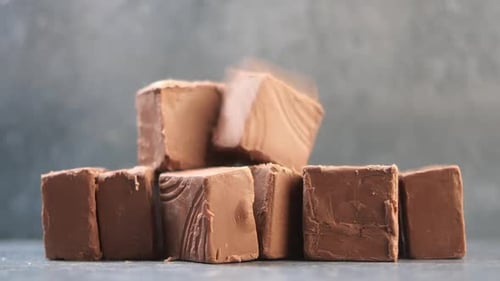 Mouthwatering Delicious Chocolate Fudge Pieces Placed on Stone Background