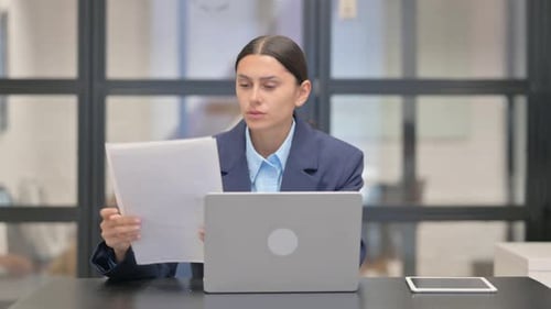 Professional Woman Works at Desk With Laptop