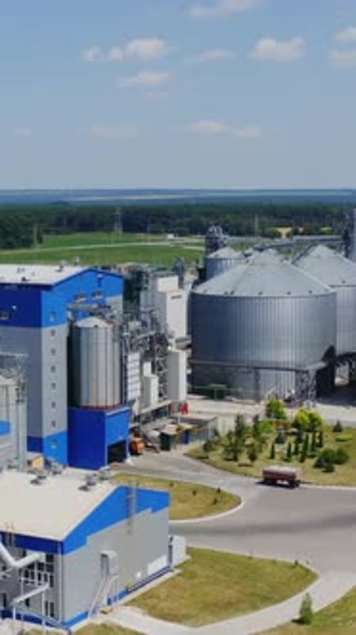 Exterior of modern plant on field. Modern large granary for agro-processing products.