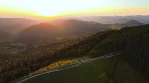 Mountain Landscape of Trekking Route Dark Dirt Road Between Spruce Woods Illuminated with Yellow