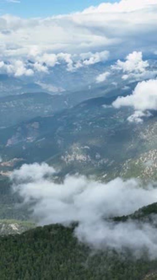 Vertical Video Aerial View of Majestic Mountains and Tranquil Reservoir Nature's Masterpiece