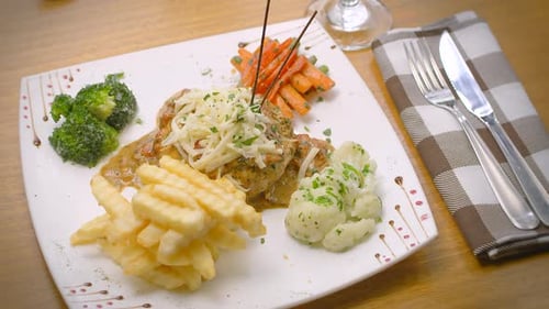 Mustard chicken with French fries, salad, and grated cheese, Mediterranean