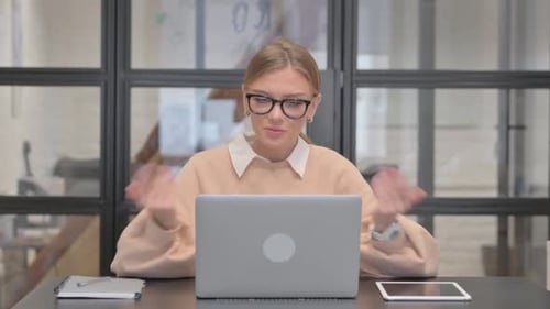 Young Woman Doing Video Chat in Office