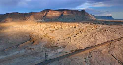 Coming near the highway in the deserted land. Beautiful bare canyons are partially