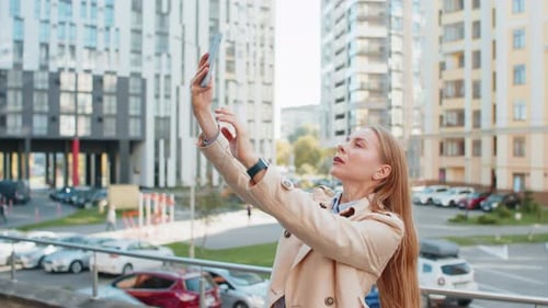 Mature Female Trying to Catch a Communication Signal or Internet on Mobile Phone on Downtown Street