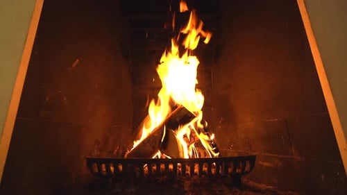Burning Fireplace with Bright Flames in Dark Interior