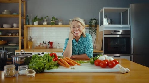 Smiling Woman with Healthy Vegetables in Bright Kitchen