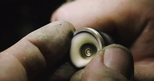Close up of the hands of a goldsmith while he is working on a diamond ring. Concept: Style, fashio