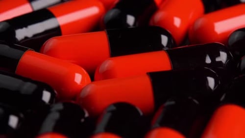 Black and Orange Capsule Pills Dolly Close-Up