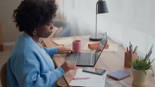 Woman Working from Home Using Laptop Computer