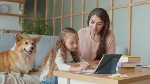 Woman Tutoring Child with Dog in Home