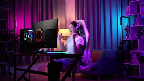 Excited Woman Playing Video Game at Computer