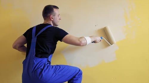 Man Painting Interior Wall with Roller