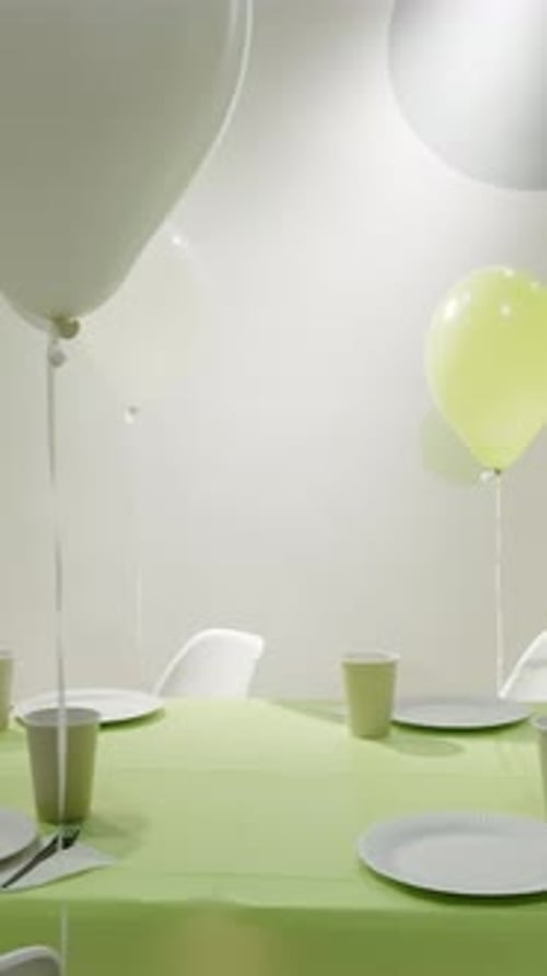 Festive Party Table with Balloons and Green Tablecloth