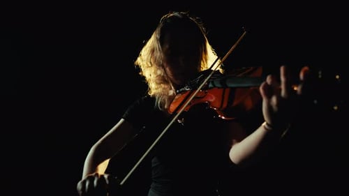 Violinist Plays in Dramatic Spotlight