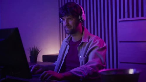 Gamer Celebrates Victory During Epic Game Stream in Cozy Home Setup at Night