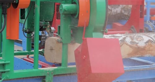 Work of the sawmill in close-up. Process of machining logs in equipment sawmill machine saw saws the