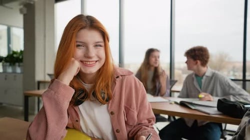 Smiling Student Studying in a Classroom