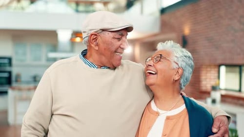 Senior Couple Embracing in Their Home, Smiling