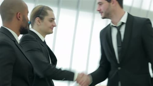 Business Professionals Meet and Shake Hands Indoors