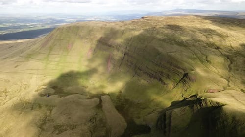 Cloudy shadows passing over Llyn y fan Fach Brecon beacons green mountain wilderness countryside aer