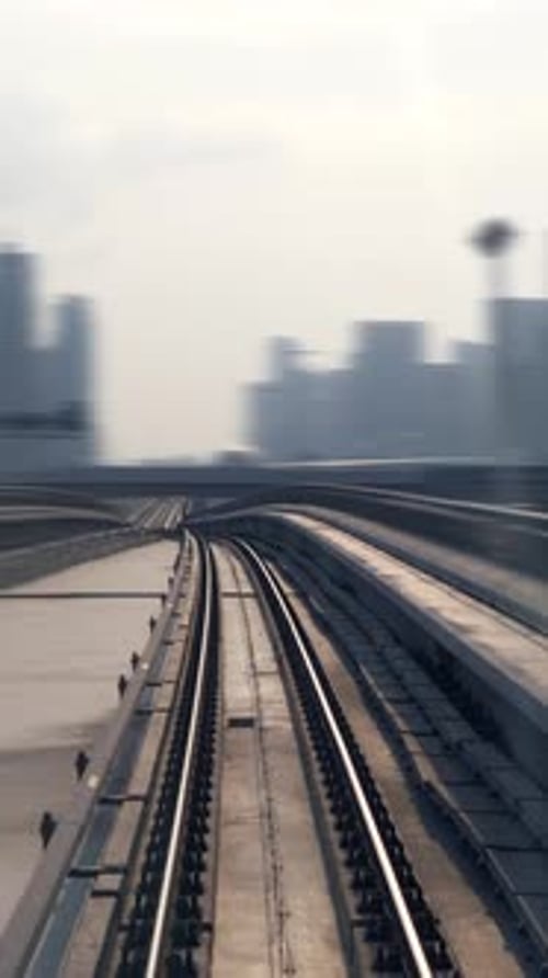 An Urban Train Tracks Scene Beautifully Showcases a Skyline View in the Background Today