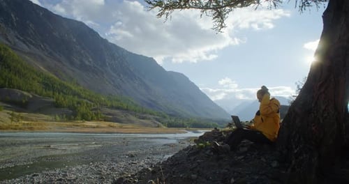 Enjoy Remote Work in Nature Using a Laptop While Surrounded By a Stunning Mountain View