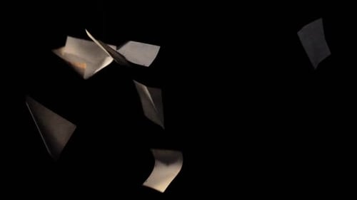 Paper Pieces Gently Falling in Slow Motion