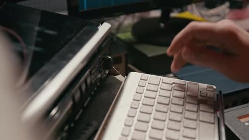Hand of Male Musician Adjusting Sound Controls in Recording Studio