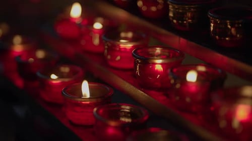 Glowing Flames of Red Votive Candles