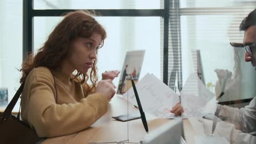 Scandalous Woman Arguing with Bank Teller in Office