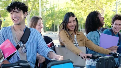 Group of young students renting bicycles in the city