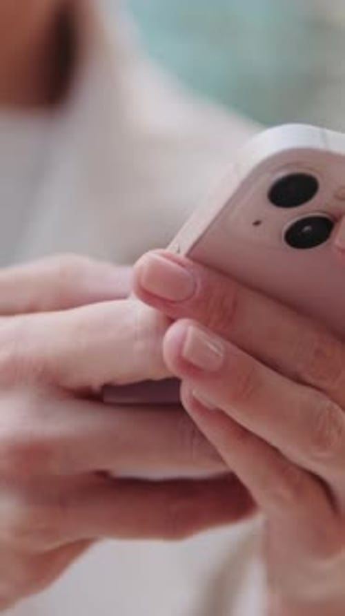 Vertical video, Woman Using Smartphone Outdoors. Close up of the phone