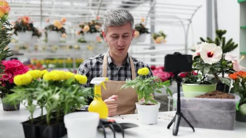 Man Plants Flowers and Films with Phone