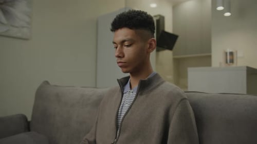 Young Adult Using Laptop on Couch at Home