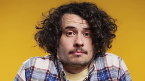 Young Adult Male with Curly Hair Making Faces