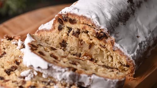 Sliced Fruitcake Sprinkled with Powdered Sugar on Wood