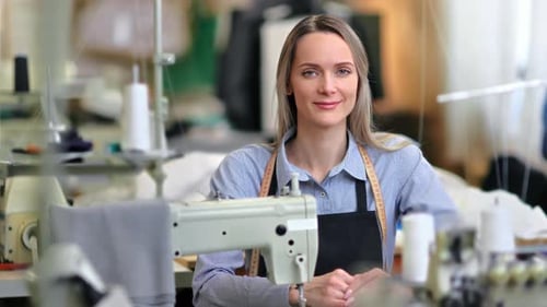 Smiling Woman Tailor in Bright Workshop