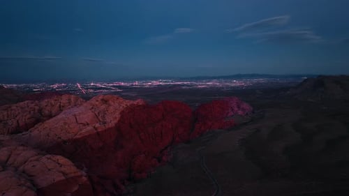 Aerial View of Red Rock Canyon at Dusk with Las Vegas Skyline in Distance