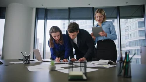 Business Team Analyzing Documents at Office Desk Colleagues Reviewing Papers