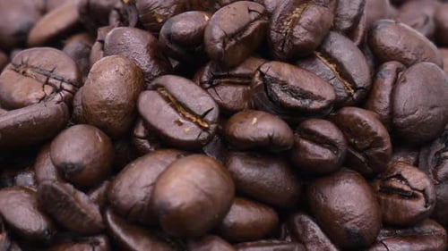 Pile Of Rich Aromatic Coffee Beans Rotating Close Up