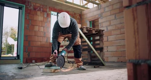 Construction worker operating angle grinder, sparks flying from metal cutting, focused on task