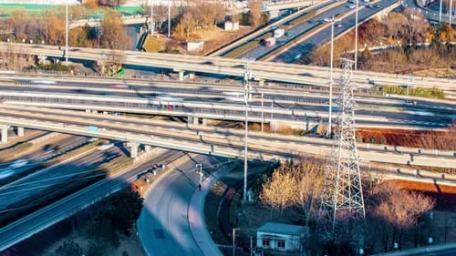Bird's night light city view of multi-level junction road lands with moving cars traffic of modern h